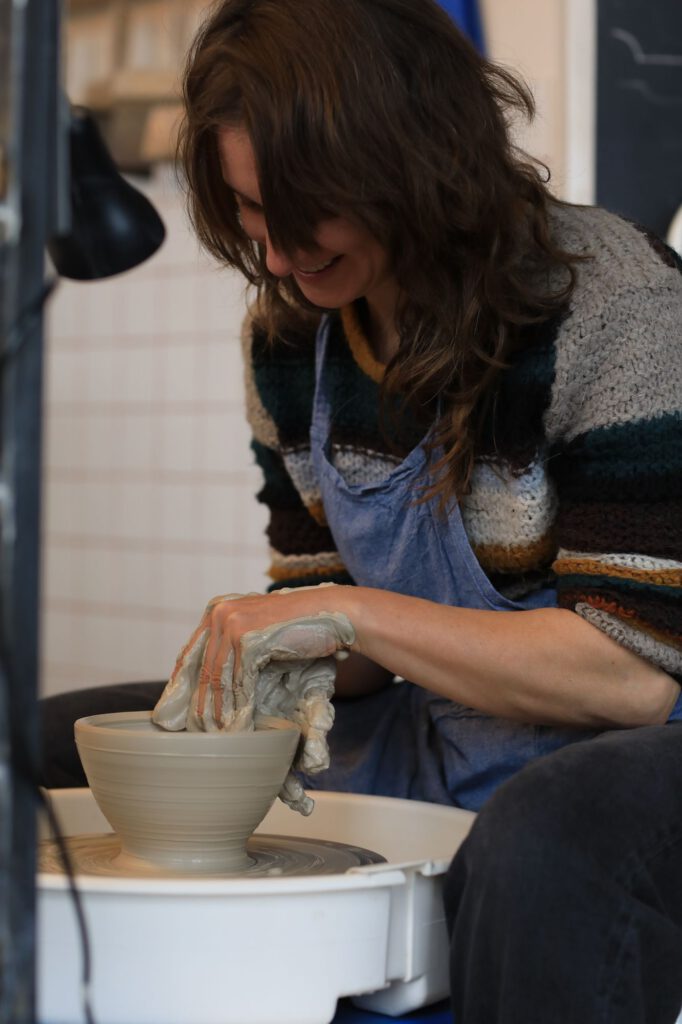 Alice Elleboode throwing a bowl in her studio
